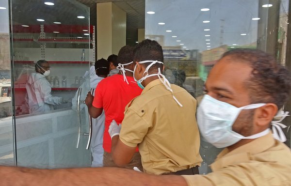 Mask-clad health workers enter the private al-Kubi Hospital in Yemen's southern coastal city of Aden on May 17th, amid fears that coronavirus is spreading unhindered in the Yemeni city. [Nabil Hasan/AFP]