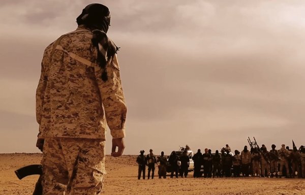 A photo posted last July by the ISIS shows one of its leaders addressing recruits in Libya. Russia's Wagner Group has been using many similar tactics that ISIS has used to recruit mercenaries to fight in Moscow's conflicts worldwide, including in Libya. [File]