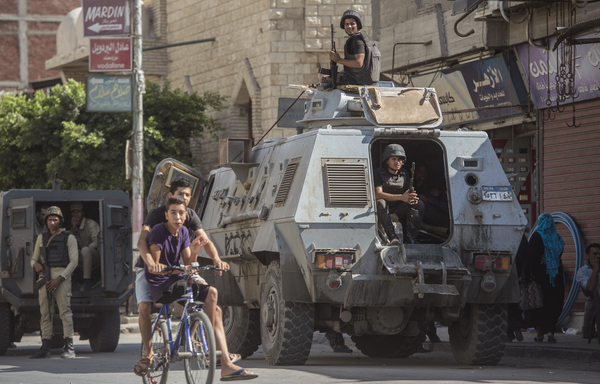 A file photo from July 26th, 2018 shows Egyptian policemen standing guard in a street in the North Sinai provincial capital of al-Arish. [Khaled Desouki/AFP]