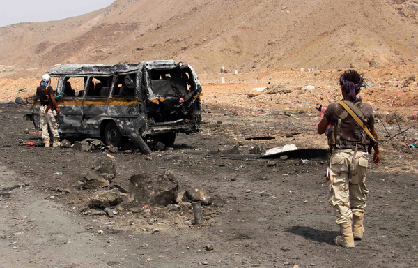 In this file photo from July 18th, 2016, Yemeni soldiers inspect the scene of a car bomb attack at an army checkpoint in Hadramaut province's Hajr district. [Abdul Jabbar Bajubair/AFP]