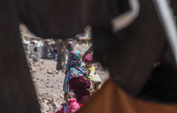 An Egyptian Bedouin woman carries an infant in the village of al-Hamada in Wadi el-Sahu in South Sinai on March 31st, 2019, in the first "Sinai Trail" led by Bedouin guide women. [Khaled Desouki/AFP]