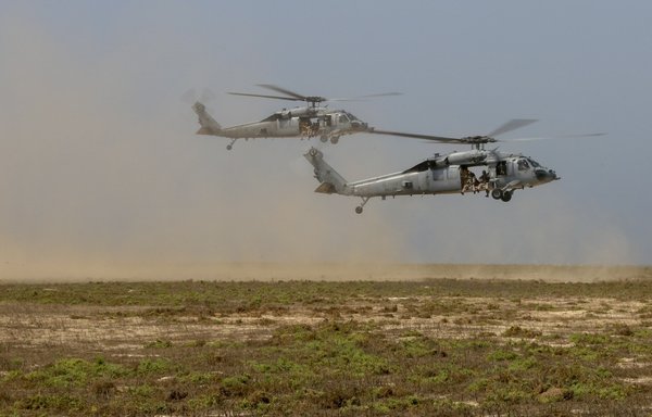 US Navy MH-60S Sea Hawks assigned to the amphibious assault ship USS Bataan operate over Karan Island, Saudi Arabia, during routine sustainment training on May 27th. [US Marine Corps]
