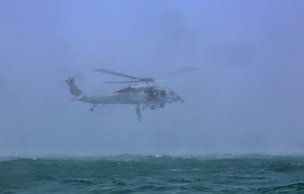 A reconnaissance Marine assigned to the Maritime Raid Force, 26th Marine Expeditionary Unit (MEU), helocasts from a US Navy MH-60S Sea Hawk on May 25th. [US Marine Corps]