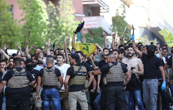 Lebanese army block supporters of Hizbullah and Amal as they shout slogans against protestors in central Beirut, on June 6th. Protestors poured into the streets of the Lebanese capital to decry the collapse of the economy, as clashes erupted between supporters and opponents of Iran-backed Hizbullah. [Anwar Amro/AFP]