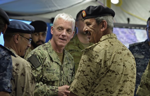 Bahrain Defence Force Commander-in-Chief, Field Marshal Sheikh Khalifa bin Ahmed Al-Khalifa (R) and US Navy Vice Admiral, James J. Malloy (C), Commander of US Naval Forces Central Command and the US 5th Fleet, are pictured at the operations centre of the International Maritime Security Construct following its opening at the US 5th Fleet Command in Manama, on November 7th, 2019. [Mazen Mahdi/AFP]