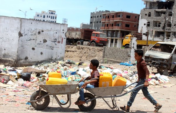Children return home after filling their jerrycans with water amid a severe shortage of water in the southern Yemeni city of Aden, on April 30th. [Saleh al-Obeidi/AFP]