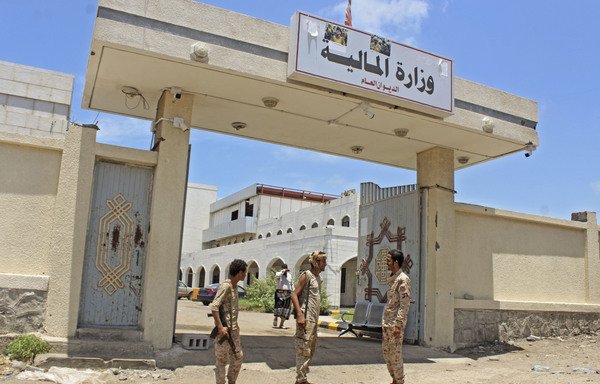 Fighters with Yemen's separatist Southern Transitional Council stand guard at the entrance of the Ministry of Finance's premises in Aden on April 26th, after the council declared self-rule in the south. [Saleh al-Obeidi/AFP]