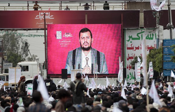 Houthi leader Abdul Malik al-Houthi is seen on a screen as he gives a speech at a rally in Sanaa on September 10th, 2019. [Mohammed Huwais/AFP]