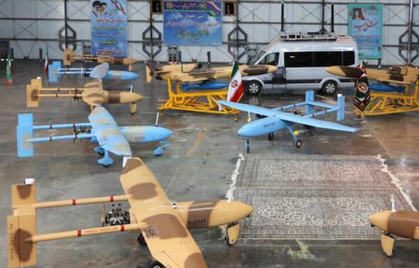 Unmanned aerial vehicles armed with missiles and explosives are displayed at a military exhibition in Iran. [Photo courtesy of Mehr News]
