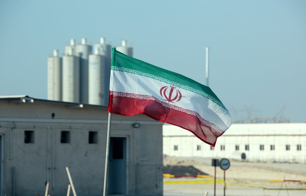 A picture taken on November 10th, 2019, shows an Iranian flag in Iran's Bushehr nuclear power plant, during an official ceremony to kick-start work on a second reactor at the facility. [Atta Kenare/AFP]