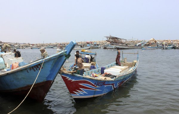 Yemeni fishermen dock at the Houthi-controlled port of al-Hodeidah on June 11th, 2019. Human Rights Watch on July 27th urged the Houthis to grant UN inspectors immediate access to a corroding oil terminal moored nearby, in order to avert an environmental disaster. [STR/AFP]