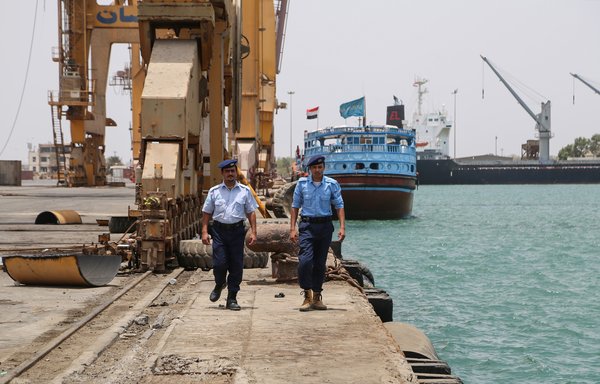 Yemeni coast guards walk at Saleef port in the western Red Sea al-Hodeidah province after their redeployment following the withdrawal of Houthi fighters, on May 13th, 2019. [AFP]