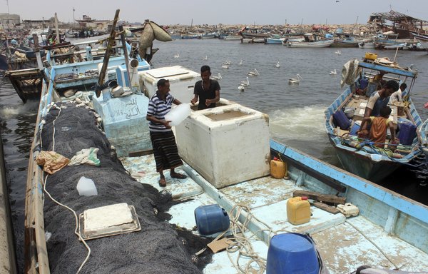 Yemeni fishermen dock their boats at the port of the Red Sea city of al-Hodeidah on June 11th, 2019. [Stringer/AFP]