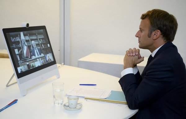 French President Emmanuel Macron listens to Lebanon president Michel Aoun during a donor teleconference concerning the situation in Lebanon with other world leaders, from Fort de Bregançon in southern France on August 9th. [Christophe Simon/POOL/AFP]
