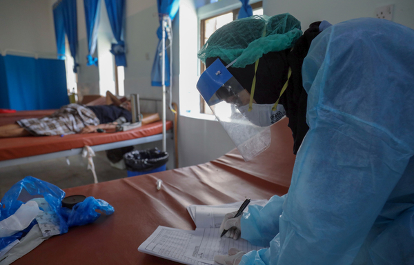 A Yemeni doctor in full hazmat suit treats a COVID-19 patient at a quarantine center in the city of Taez on June 21st. A dentist from the province was killed by al-Qaeda gunmen on August 15th. [Ahmad al-Basha/AFP]