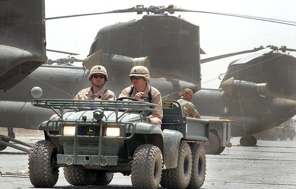 In this file photo taken July 2nd, 2002, US soldiers drive past Chinook helicopters at Bagram air base. Iran offered the Taliban bounties to attack US and coalition soldiers in Afghanistan, CNN reported on August 17th, citing US military intelligence. [Jewel Samad/AFP]