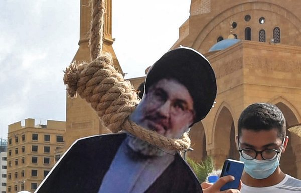 A picture shows a noose with the portrait of Hizbullah leader Hassan Nasrallah hung by Lebanese protestors in downtown Beirut on August 8th during a demonstration against a political leadership they blame for the August 4th blast. [AFP]