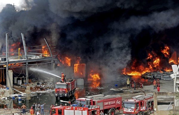 Lebanese firefighters try to put out a fire that broke out at Beirut's port area, on September 10th. [Anwar Amro/AFP]