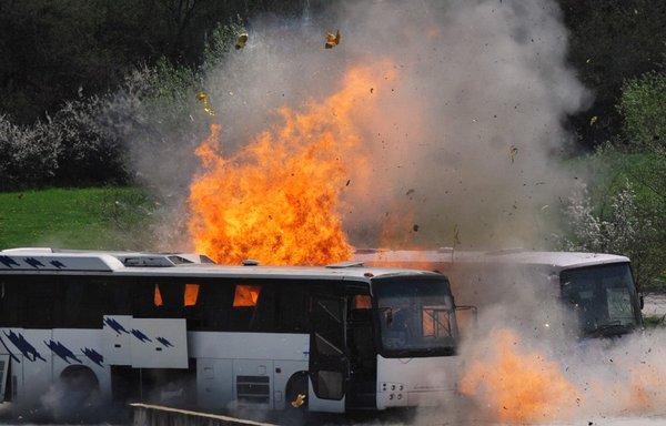 Two buses explode on April 26th, 2013 as investigators re-enact the July 2012 Burgas airport bus bombing that killed five tourists near the town of Ihtiman in an effort to resolve some of the many still unanswered questions. [Nickolay Doychinov/AFP]