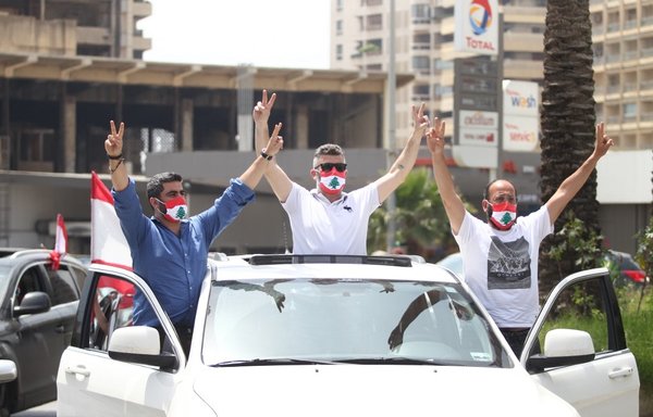 Lebanese protestors take to the streets in Beirut on April 21st in a car convoy to protest against deteriorating living conditions and maintain pressure on a political elite under fire since mass protests erupted in October. [Ibrahim Amro/AFP]