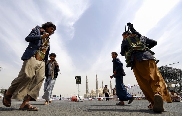 Houthi fighters stand guard in Sanaa on September 24th during a ceremony to collect cash, food and other donations for Houthi fighters. [Mohammed Huwais/AFP]