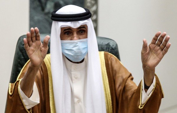 Sheikh Nawaf al-Ahmad Al-Sabah salutes the crowd after being sworn in as Kuwait's new emir at the National Assembly in Kuwait City on September 30th. [Yasser Al-Zayyat/AFP]