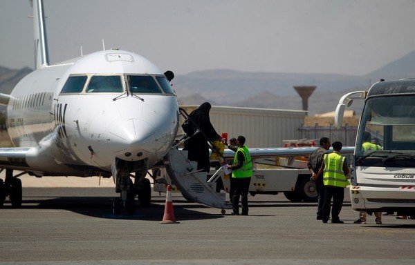 Yemenis who were airlifted to Jordan to undergo treatment for critical illnesses earlier this year, disembark from a UN aircraft upon their arrival in Sanaa, on October 4th. [Mohammed Huwais/AFP]