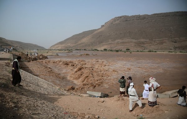 Yemenis watch flooded waters in Marib province on August 4th. [AFP]