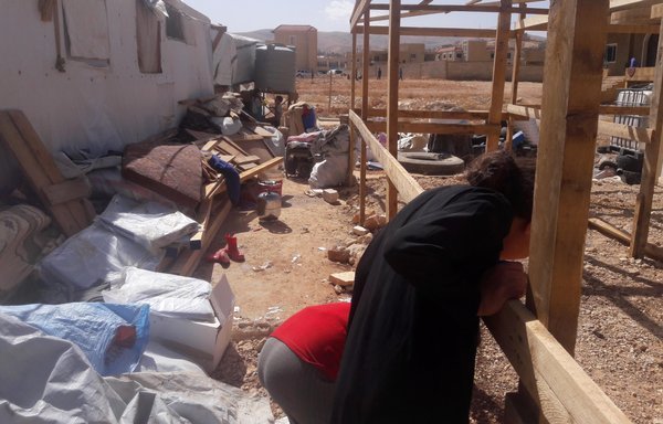 Arsal refugees work on improving tent structures ahead of winter. [Photo courtesy of NGO Syrian Refugee Voice]