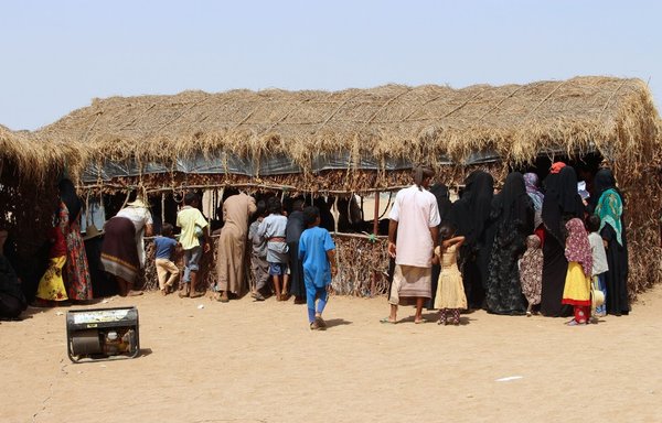 Displaced Yemenis gather outside a mobile clinic set up by a local medical organisation in Bani Hasan in 2018. [Essa Ahmed/AFP]