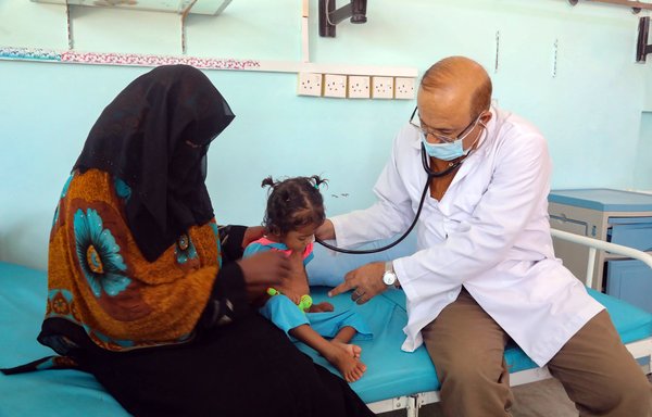 A Yemeni child suffering from malnutrition is examined by a doctor at a treatment centre in the country's third-city of Taez, on October 28th. [Ahmad al-Basha / AFP]