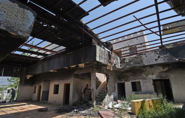 In this file photo from October 3rd, 2017, Saudi border guards stand inside a building which was reportedly hit by Houthi shelling in al-Khubah area in Jizan province. [Fayez Nureldine/AFP]