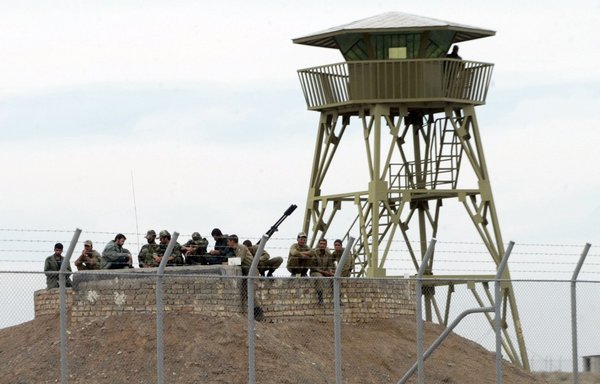 In this file photo from 2006, Iranian soldiers gather around an anti-aircraft machine gun inside the uranium enrichment facility in Natanz. [Behrouz Mehri/AFP]