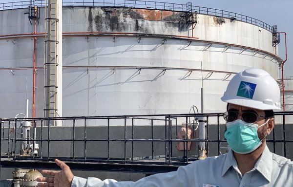 An employee at the Saudi Aramco oil facility gestures while standing near a damaged silo at the Jeddah plant on November 24th, a day after the Houthis launched a missile attack on the facility, triggering an explosion and a fire in a fuel tank. [Fayez Nureldine/AFP]