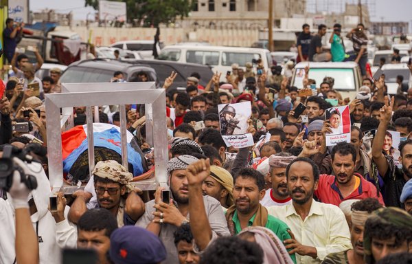Saad, the brother of Yemeni journalist and AFP contributor Nabil Hasan al-Quaety, is assisted by mourners as they carry his body during his funeral procession in Aden's Mansoura district on June 4th. [AFP]