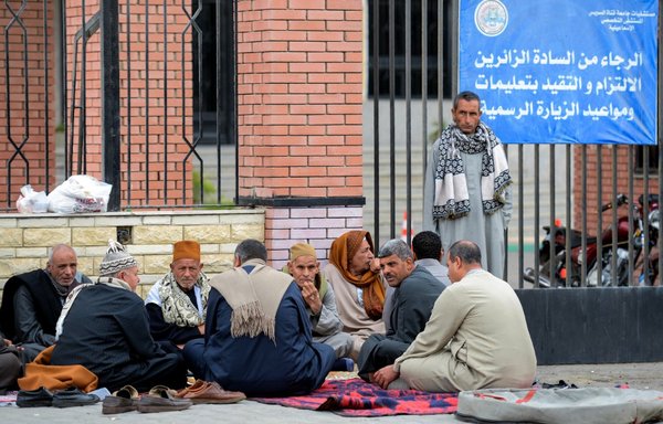 Relatives of the victims of the assault on North Sinai's Rawda mosque wait outside the Suez Canal University hospital in Ismailia on November 25th, 2017, where they were taken to receive treatment following the deadly attack the day before. [Mohamed el-Shahed/AFP]