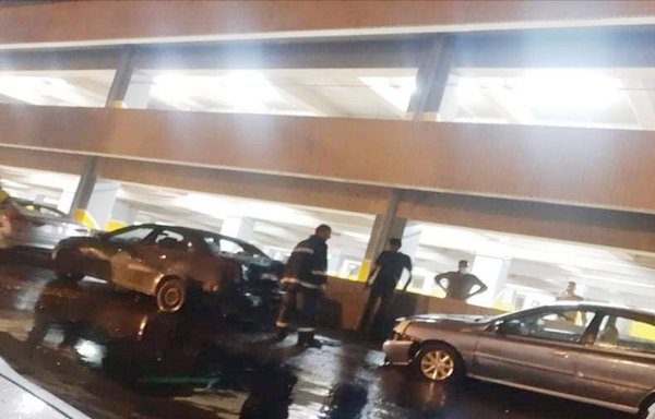 Iraqis gather near cars that were damaged on September 6th when Iranian-made Katyusha rockets hit the parking structure at the Baghdad airport. [Photo courtesy of Baghdad International Airport]