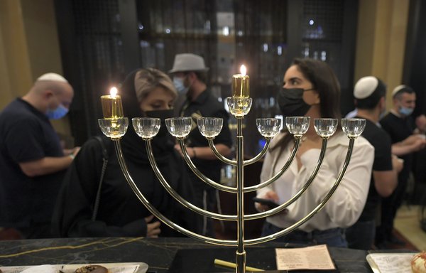 Israeli entrepreneurs celebrate the Jewish holiday of Hanukkah for the first time at a hotel in Dubai on December 10. [Karim Sahib/AFP]