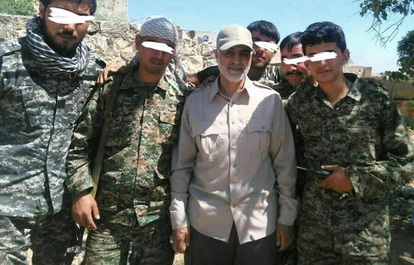 Photo posted by the Fatemiyoun Division on December 15 of Qassem Soleimani with a number of very young Afghans in Syria. [File]