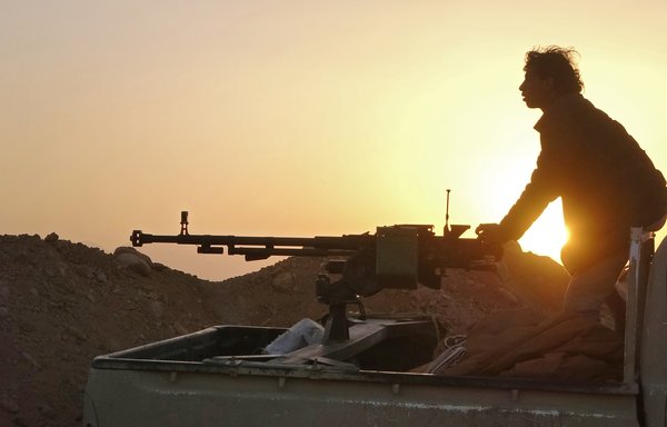 A combatant mans a heavy machine gun as forces loyal to Yemen's government clash with Houthi fighters in al-Jadaan, about 50 kilometres northwest of Marib in central Yemen on November 22, 2020. [AFP]