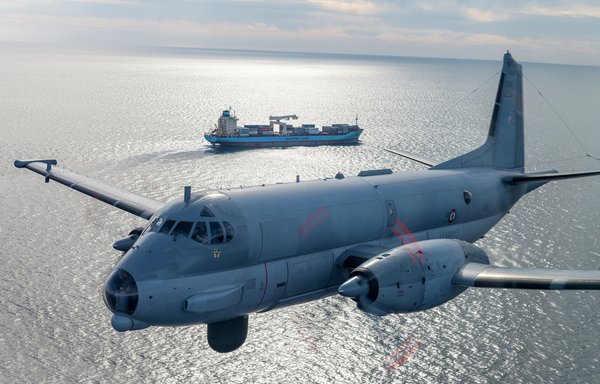An aircraft operating as part of the military component of the EMASOH initiative flies over a container carrier in the Gulf region. [French Ministry of the Armed Forces]