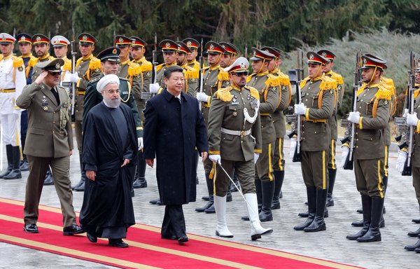 Iranian President Hassan Rouhani and Chinese President Xi Jinping review troops during a welcoming ceremony on January 23, 2016, in Tehran. The secretive pact between the two nations now being finalised reportedly began forming during this state visit. [STR/AFP]