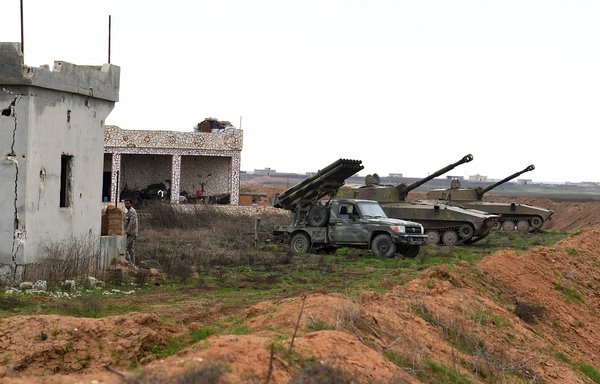 A picture taken on February 5, 2020 shows Syrian self-propelled artillery and a Katyusha rocket launcher positioned in the town of Tell Sultan, in Syria's northwestern Idlib province. [AFP]