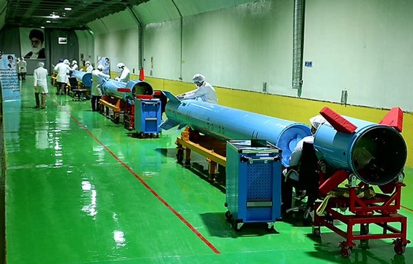 Specialists work on long-range rockets in an underground facility run by Iran's Islamic Revolutionary Guard Corps (IRGC). [IRGC]