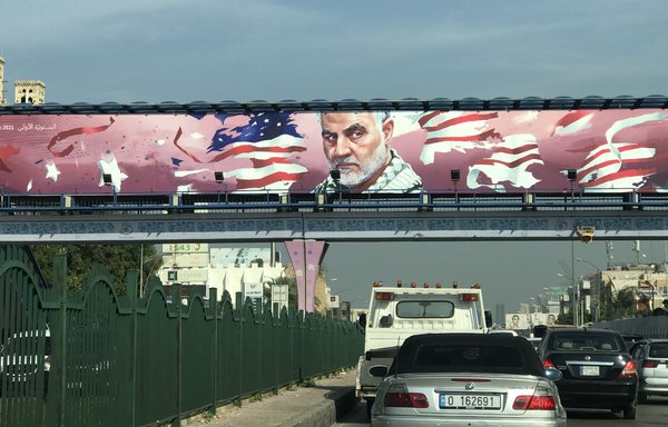 A billboard depicting the late IRGC Quds Force commander Qassem Soleimani hangs over a Beirut street in an area of Hizbullah influence. [Nohad Topalian/Al-Mashareq]