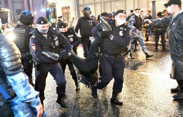 Russian police officers July 15 in Moscow detain a man protesting the results of a July 1 referendum. The vote approved reforms to the Russian constitution. They enable President Vladimir Putin to stay in power until 2036. [Dimitar Dilkoff/AFP]