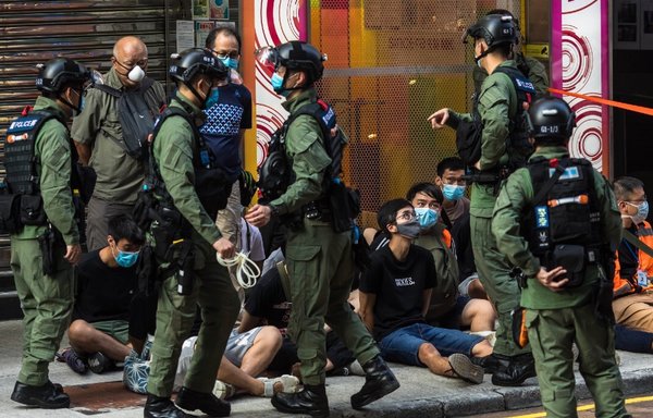 Chinese police in Hong Kong September 6 arrest protesters rallying against the government's postponement of the legislative council election and against the national security law used to silence domestic dissent. [Dale de la Rey/AFP]