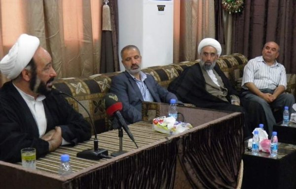 Political and religious figures look on as Hizbullah operative Muhammad Kawtharani (left) delivers a lecture in 2014 in the Lebanese city of Bint Jbeil. [bintjbeil.org]
