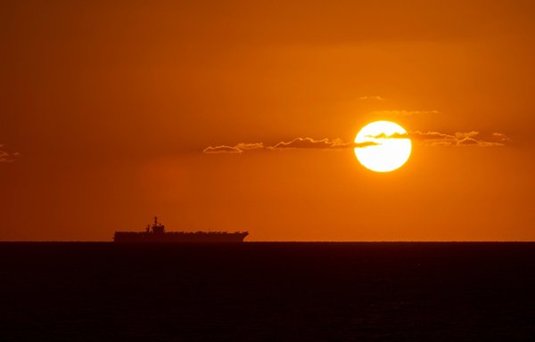 The aircraft carrier USS Nimitz is shown as the sun sets. The Nimitz has been operating in the waters around the Gulf since November. [CENTCOM]