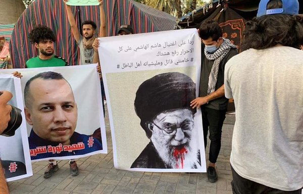 Iraqis gather in Baghdad's Tahrir Square July 7, carrying a poster of Iranian supreme leader Ali Khamenei to denounce Iran's interference in their country and condemn the assassination of security expert Hisham al-Hashemi. [Twitter]
